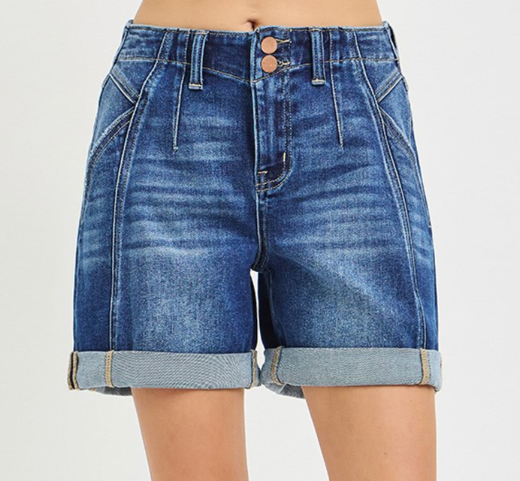 Blue denim shorts on a plain background