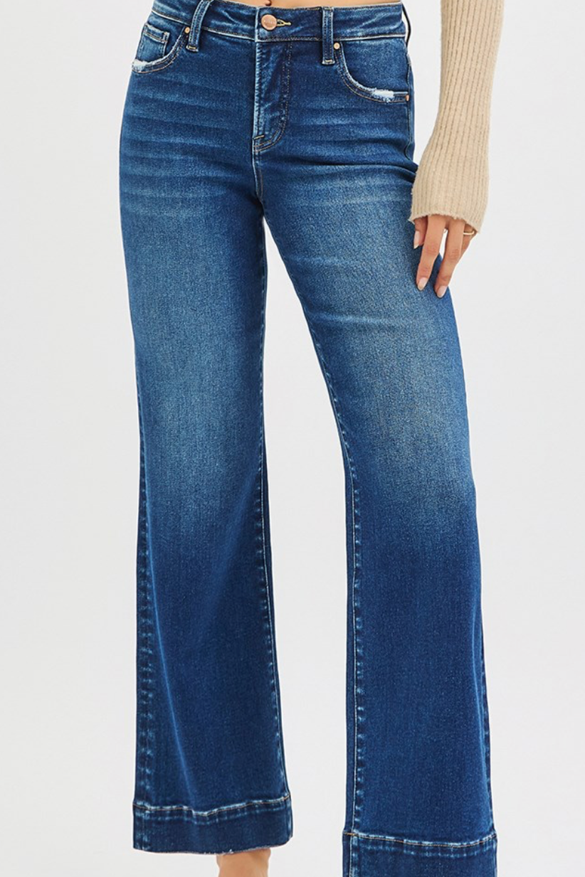 Blue jeans worn by a person on a white background