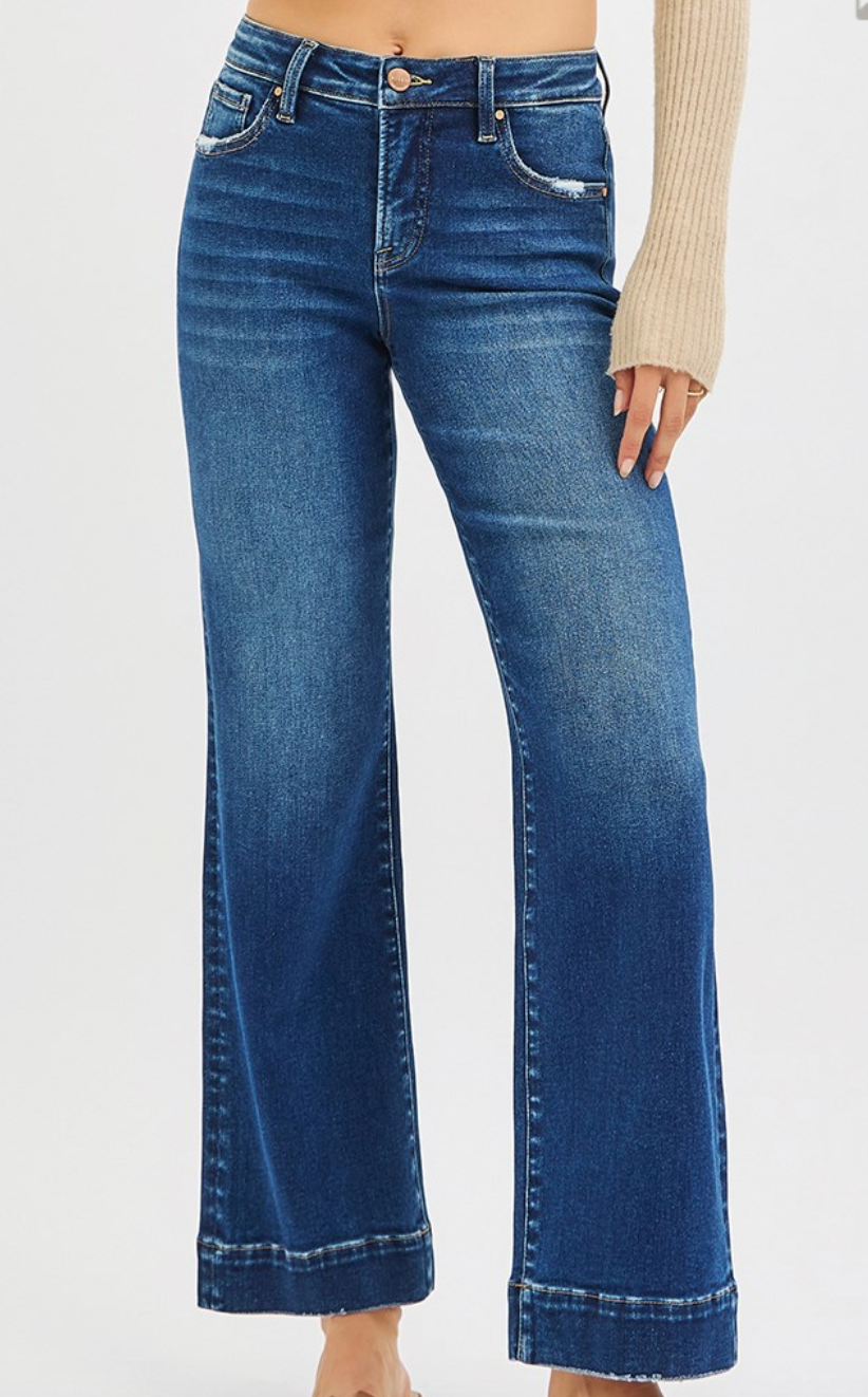 Blue jeans worn by a person on a white background