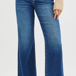 Blue jeans worn by a person on a white background