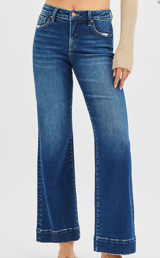 Blue jeans worn by a person on a white background