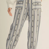 Striped pants with a subtle pattern on a neutral background