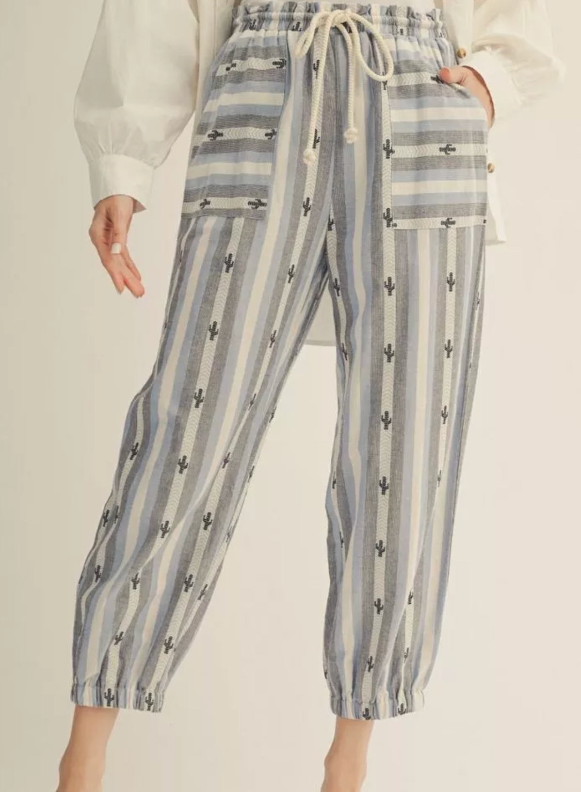 Striped pants with a subtle pattern on a neutral background