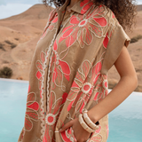 Woman wearing a floral dress with a desert landscape in the background