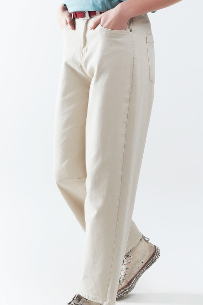 Person wearing light-colored pants and a blue shirt on a white background