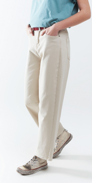 Person wearing light-colored pants and a blue shirt on a white background