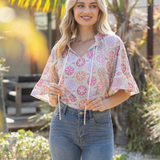 Woman wearing a floral blouse and jeans outdoors