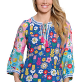 Woman wearing a colorful floral blouse with a white background