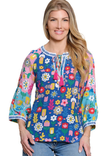 Woman wearing a colorful floral blouse with a white background