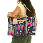 Woman carrying a colorful butterfly-patterned bag on a white background