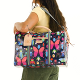 Woman carrying a colorful butterfly-patterned bag on a white background