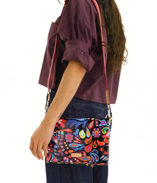 Person wearing a colorful patterned bag with a white background