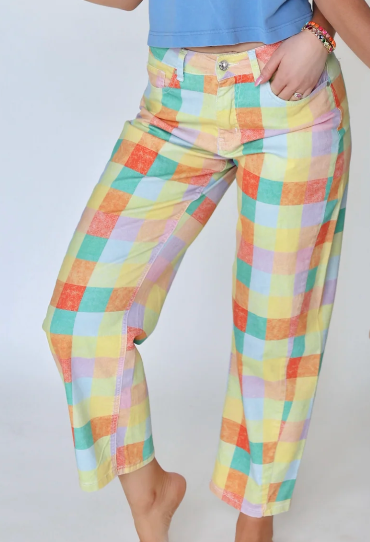 Colorful checkered pants worn by a person on a white background