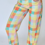 Colorful checkered pants worn by a person on a white background