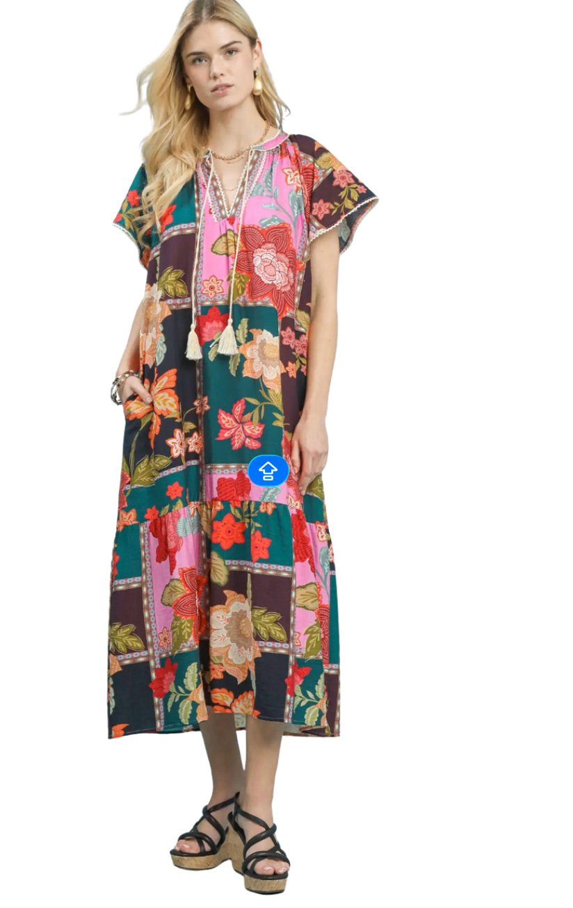 Woman wearing a colorful floral dress on a white background