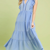 Woman wearing a light blue dress on a green background