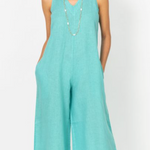 Woman wearing a light blue jumpsuit on a white background