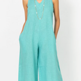 Woman wearing a light blue jumpsuit on a white background