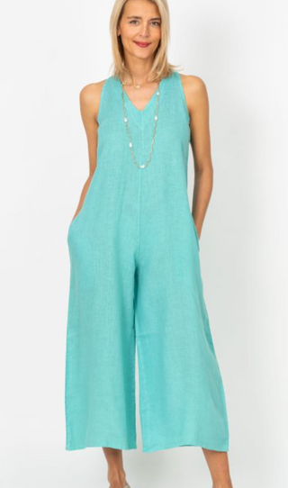 Woman wearing a light blue jumpsuit on a white background
