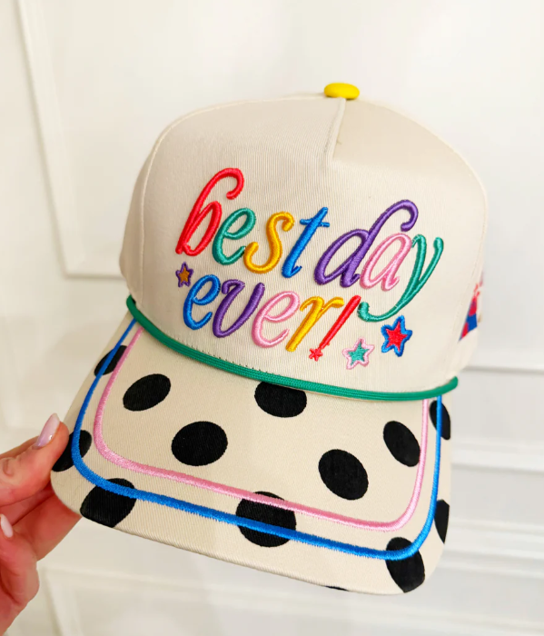 Cap with 'best day ever!' text in colorful letters on a white background