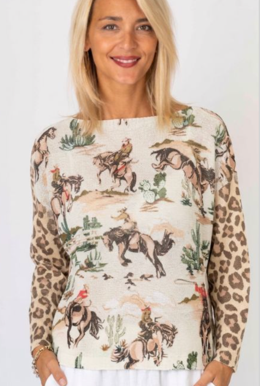 Woman wearing a long-sleeve shirt with horse and leopard print design.
