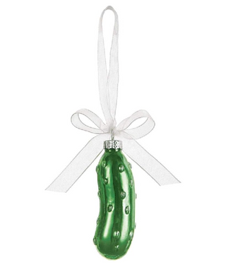 Green pickle ornament with a white ribbon on a white background