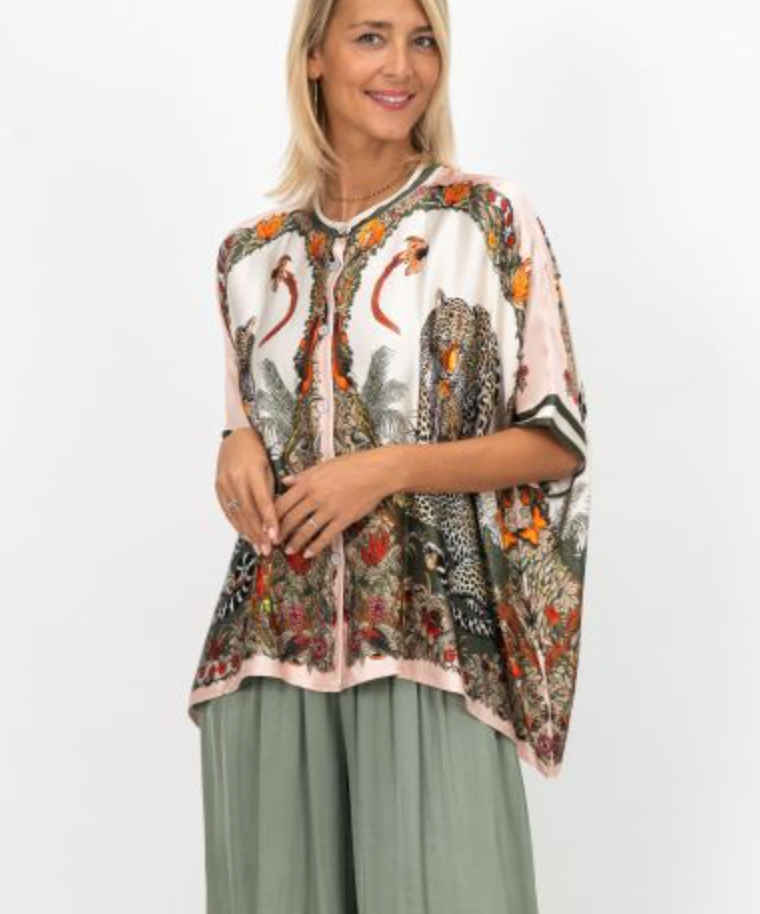 Woman wearing a patterned blouse with a white background