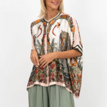 Woman wearing a patterned blouse with a white background