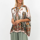 Woman wearing a patterned blouse with a white background