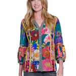Woman wearing a colorful floral jacket on a white background