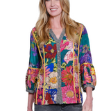 Woman wearing a colorful floral jacket on a white background