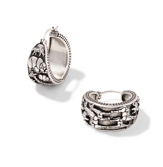 A pair of silver hoop earrings with detailed animal and floral engravings, shown on a clean white background.