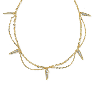 A gold multi-strand necklace featuring five pointed spike charms, each adorned with small clear pavé stones, set against a plain white background.