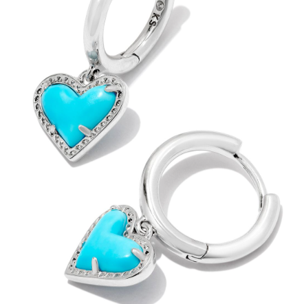 Silver hoop earrings with turquoise heart charms on a white background
