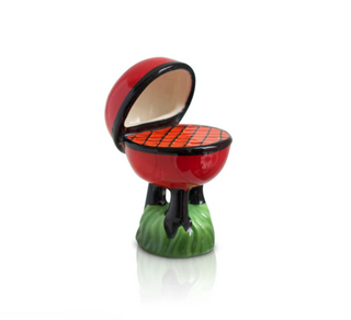 Small ceramic model of a barbecue grill with open lid on a white background