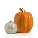 Two ceramic pumpkins, one large and one small, with gold accents on a white background.