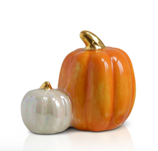 Two ceramic pumpkins, one large and one small, with gold accents on a white background.