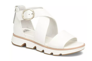 White sandal with a gold buckle on a white background