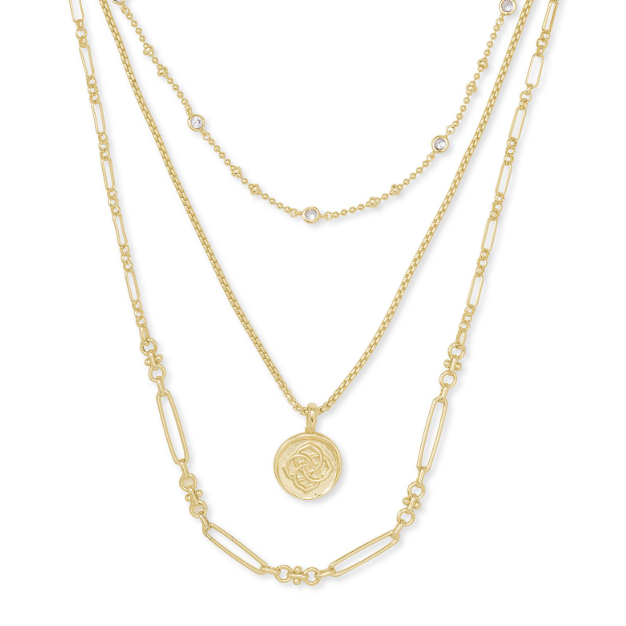 Gold necklace with a circular pendant on a white background