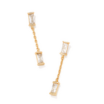 Gold earrings with clear gemstones on a white background