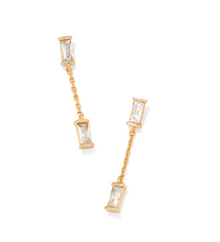 Gold earrings with clear gemstones on a white background