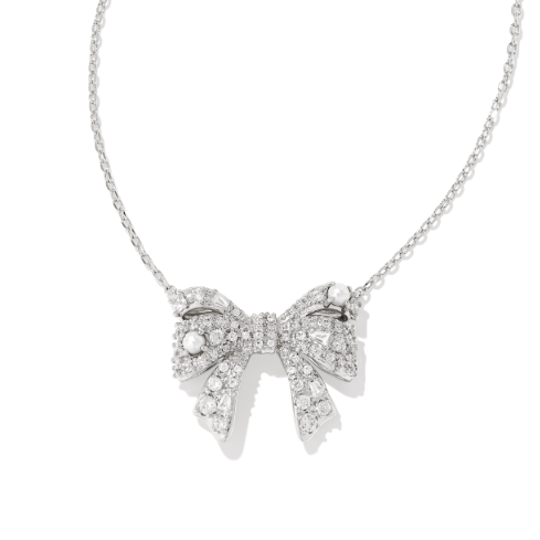 Silver bow-shaped necklace with clear stones on a white background