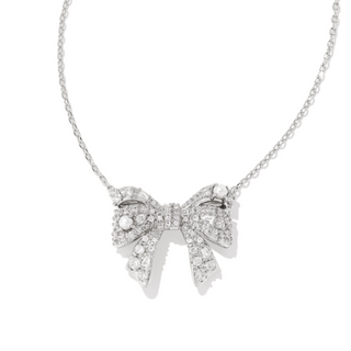 Silver bow-shaped necklace with clear stones on a white background