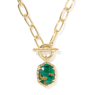 Gold chain necklace with a green pendant on a white background