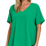 Woman wearing a green V-neck t-shirt on a white background