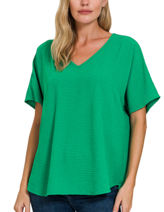 Woman wearing a green V-neck t-shirt on a white background