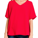 Red blouse worn by a person on a white background
