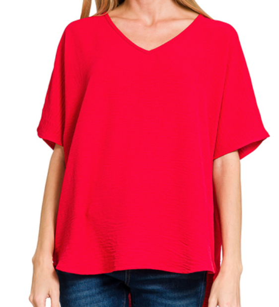 Red blouse worn by a person on a white background
