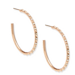 Rose gold hoop earrings with embedded stones on a white background