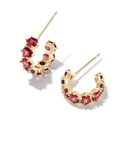 Gold hoop earrings with red gemstones on a white background